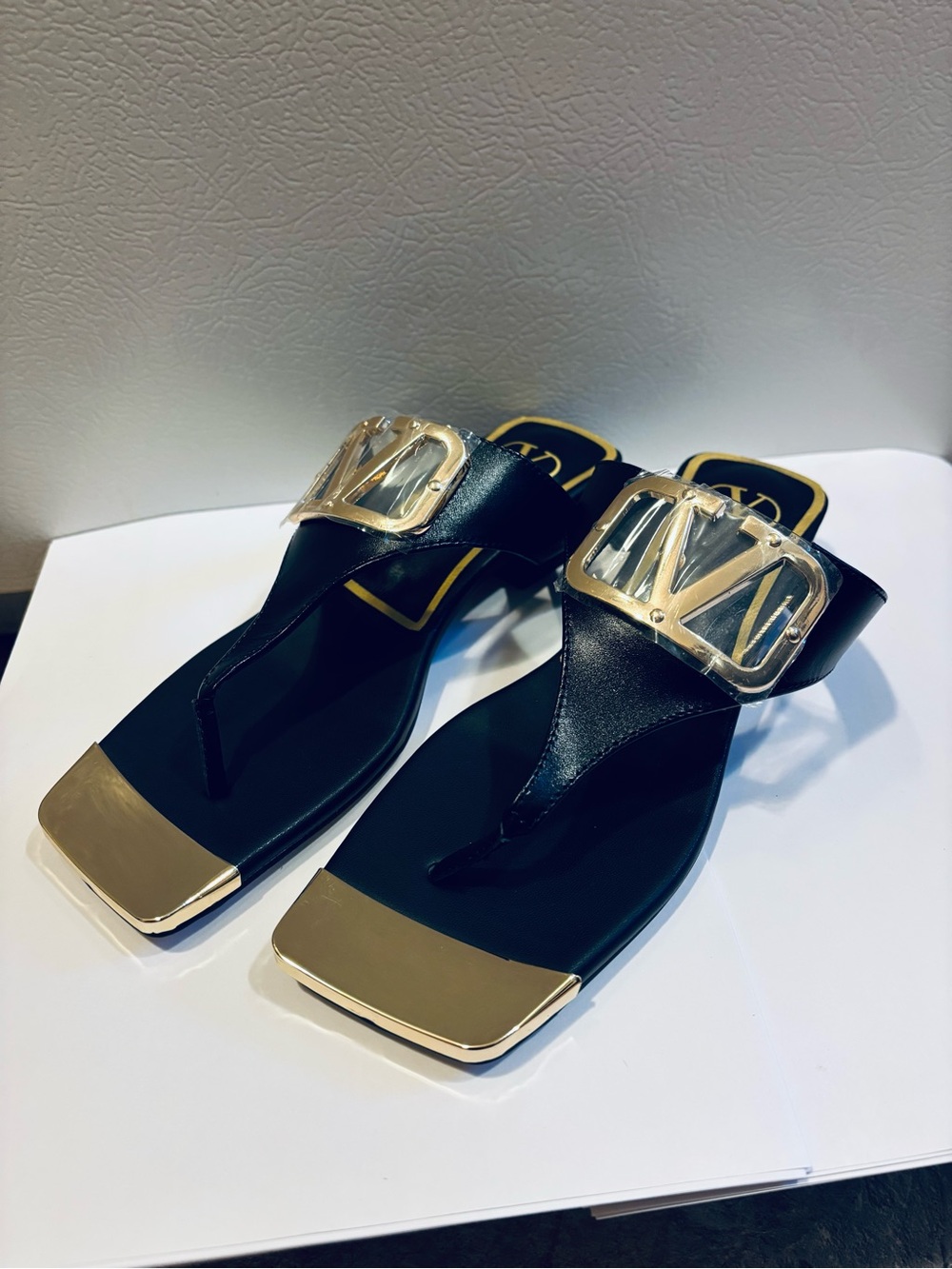 Valentino Garavani Black Thong Sandals with Gold Hardware